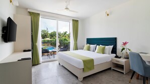 A hotel room with a bed, a desk, a chair, a TV, and a balcony with a pool. - Sibaya Courtyard By Stone Wood Premium  (Baga)