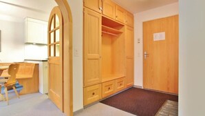 A room with a wooden wardrobe, a desk, and a chair. - Jasmin 202 Appartement/Fewo, Dusche oder Bad, WC 2½-Zimmerwohnung by Interhome (Davos)