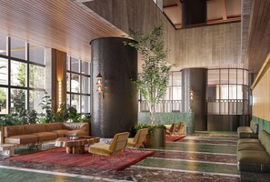 A spacious lobby with a large seating area, a tall pillar, and a potted plant. - Bright Apt Southbank Near Crown Casino ,pool &gym (Melbourne)
