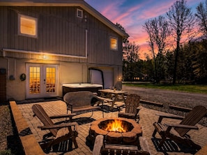 A house with a fire pit, outdoor seating, and a garage. - Sleeps 12 • Hot Tub • 5 Min to Lake Beach (Long Pond)