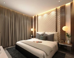 A modern hotel room with a large bed, bedside tables, and a wall with a quilted pattern. - SUNPARKINN BARNALA (Barnala)