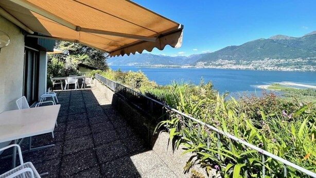 A terrace with outdoor seating, a view of a lake, and mountains in the background. - Casa Poggio Verde by Interhome (Magadino)