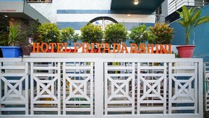 A hotel sign with the name 'HOTEL PRIYADARSHINI' in large letters.
