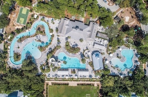 An aerial view of a resort with multiple swimming pools, a tennis court, and lush landscaping. - Updated*Near Pool*Golf Cart,Bikes,Sleeps 10*New Mattresses*Watercolor Amenities (Santa Rosa)
