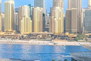 A coastal cityscape with high-rise buildings, a beach, and a marina. - Vogue | Bluewaters Residences steps away from Ain Dubai and Wharf Mall (Dubai)