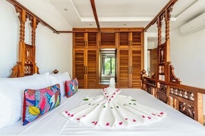A hotel room with a bed, wooden headboard, and a view through a door. - Tranquil 2-bedroom apartment with AC in Diani Beach (Diani Beach)