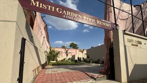 A gated entrance to Misti Garden Pool Resort with a clear sky. - Misti Pool And Resort (Jaipur)