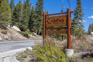 A wooden sign for 'The Cabins Crooked Pines' at 2004 Lodestar Drive. - Beautiful 2/2 Golf/Ski Condo-Garage, Jacuzzi, BBQ! (Mammoth Lakes)