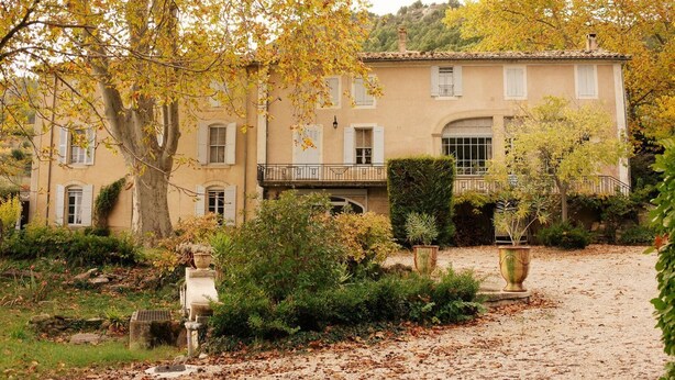 Un bâtiment de style traditionnel, doté d’une façade symétrique, de nombreuses fenêtres et d’un balcon central.