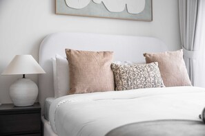 A neatly made bed with two pillows, a bedside lamp, and a framed artwork on the wall. - Free Housekeeping Visits During Your Stay - Stayshort - Modern Studio That Sleeps 4 at Riviera Beachfront (Dubai)