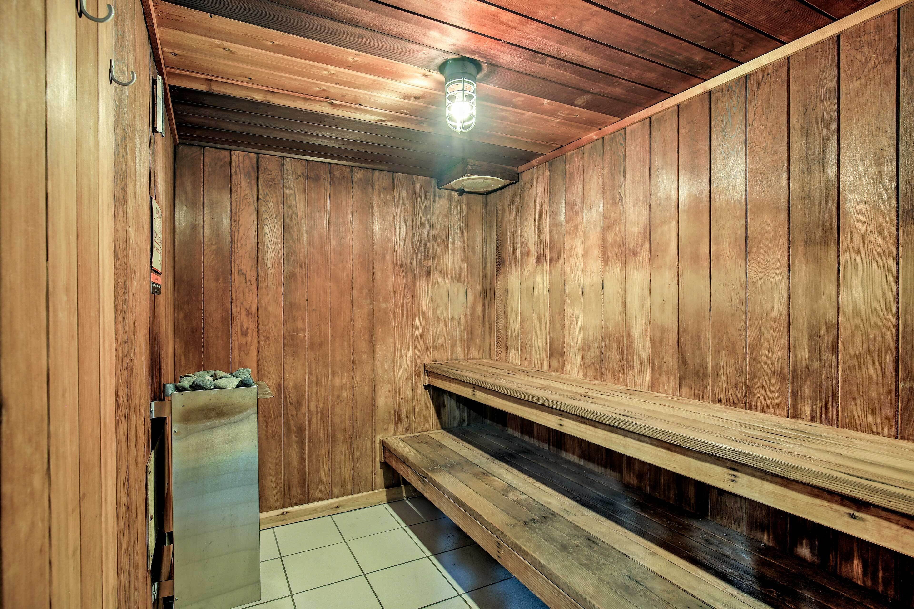 A wooden sauna with benches and a light fixture.