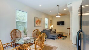 A modern kitchen with a dining area, a sofa, and a flat-screen TV. - Potomac Riverfront! Home Near St Clements Island (Coltons Point)