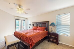 A bedroom with a bed, a bench, a nightstand, a lamp, and a ceiling fan. - 2BR Condo in Fountain Hills w/ Mountain Views (Fountain Hills)