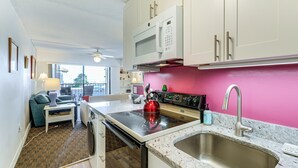 A compact kitchen with a microwave, stove, and sink. - 200 Feet to the Beach! Cute Ocean City Condo (Ocean City)