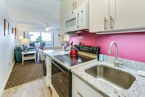 A compact kitchen with a microwave, stove, and sink. - 200 Feet to the Beach! Cute Ocean City Condo (Ocean City)