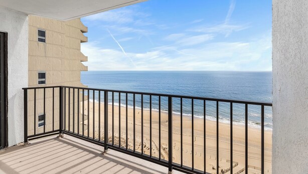 A balcony with a view of the beach and ocean. - Plaza 1612 2bd Oceanfront condo (Ocean City)