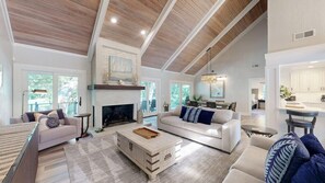 A spacious living room with a fireplace, a dining area, and a kitchen. - 15 Rum Row: 3  BR, 3  BA House in Hilton Head Island, Sleeps 6 (Hilton Head Island)