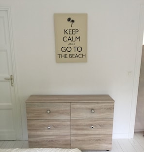 A wall with a motivational quote and a wooden dresser with drawers. - Royan: Bright family villa for 11 people - 7 min from Pontaillac beach (Royan)