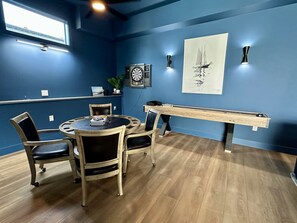 A room with a dartboard, a painting, a pool table, and a round table with chairs. - Spa • Theater • Sauna • Hot Tub • Arcade • Pets (Ocean Shores)