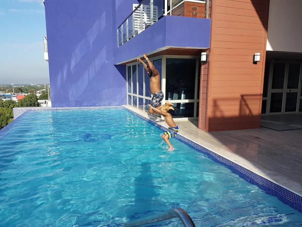 A swimming pool with a person performing a dive.