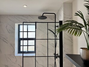 A shower enclosure with a window, a potted plant, and a marble-tiled wall. - Luxury/Hot tub/sauna/Sleeps 9/ Parking (Chepstow)