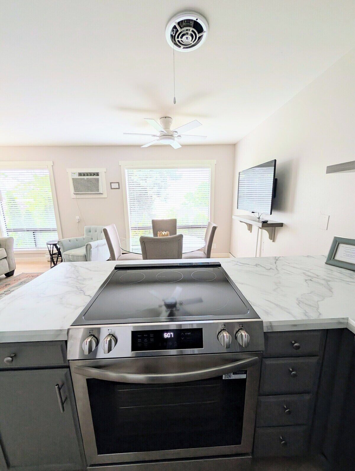 A modern kitchen with a built-in stove, oven, and a ceiling fan.