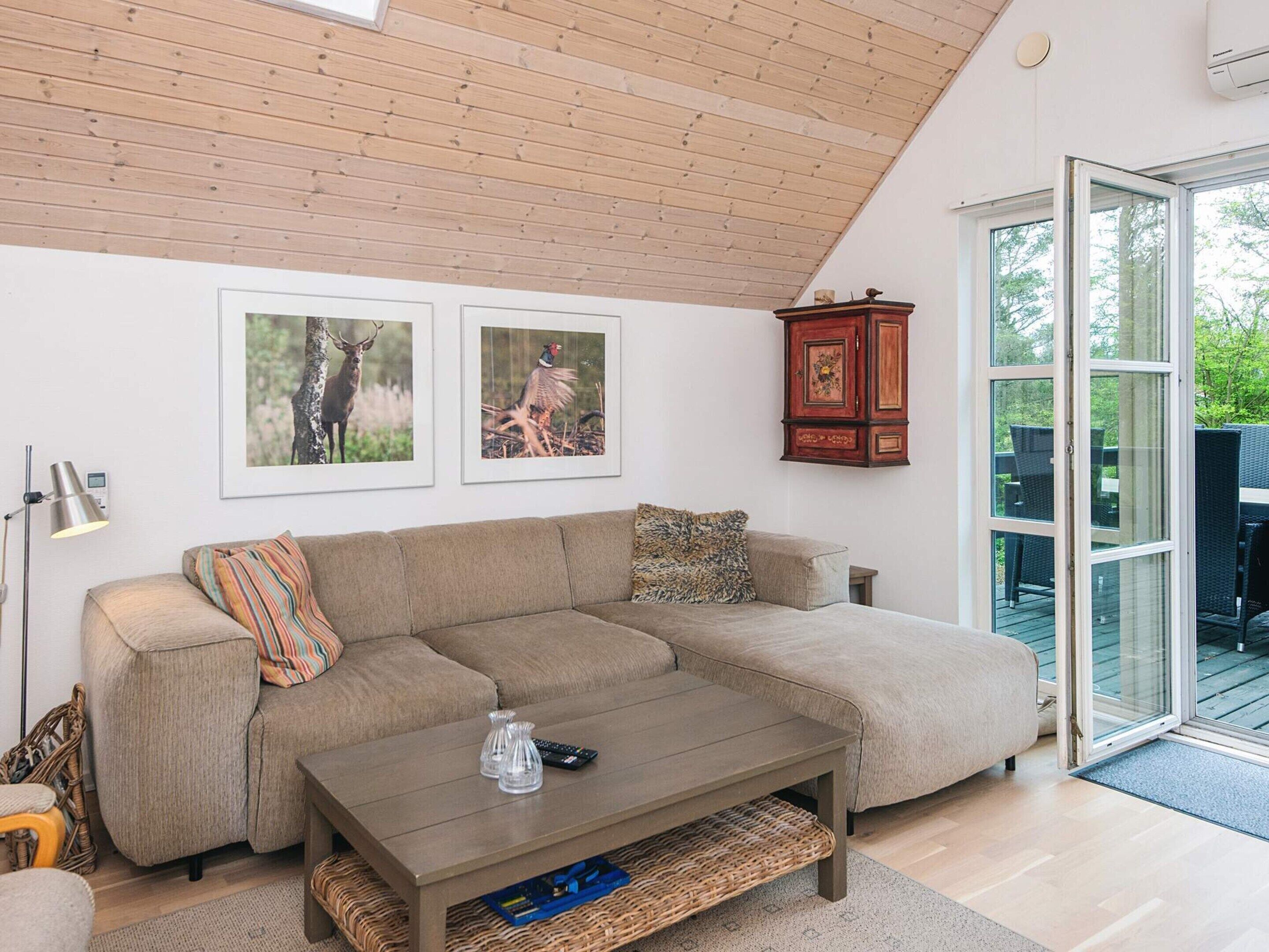 A living room with a sofa, coffee table, and wall-mounted cabinet.