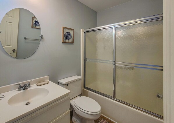 A bathroom with a toilet, sink, and shower. - Queen's Grant E-216 - NEW - Open Summer Weeks! (Topsail Beach)