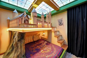 Enjoy a whimsical sleeping nook featuring a charming castle-themed bed with delightful turrets and cozy lighting. The vibrant red and gold bedding adds playfulness, and the skylight brings in beautiful natural light. - 10BR house sleeps 28 near Disney area (Clermont)