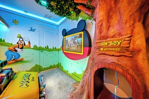 Welcome to a whimsical kids' zone with colorful murals of beloved characters and a cozy treehouse nook for fun adventures. The soft lighting and playful decor create an enchanting atmosphere that sparks joy and imagination. - 10BR house sleeps 28 near Disney area (Clermont)