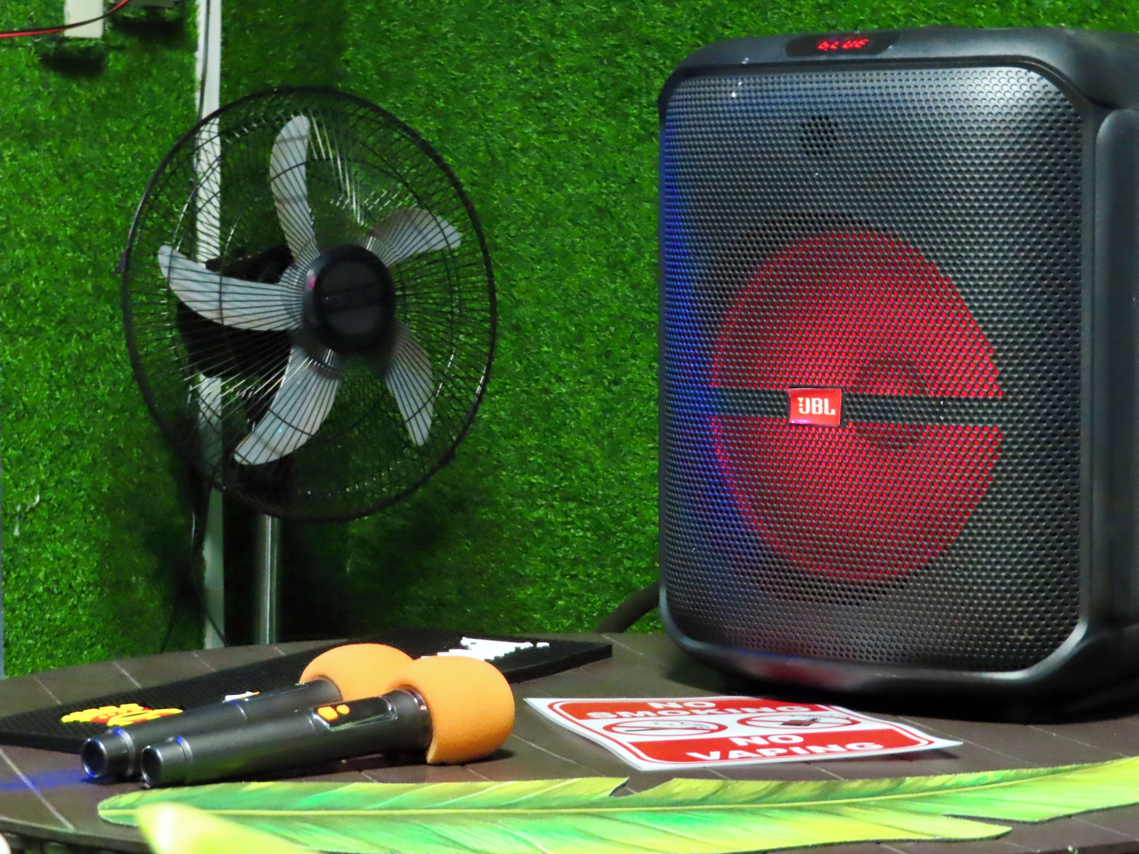 A table with a fan, a speaker, and a 'No Smoking' sign.