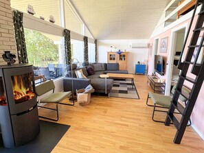 A cozy living room with a fireplace, comfortable seating, and a television. - 7 Person Holiday Home in Skals (Skals)