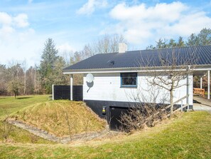 A single-story house with a satellite dish, a small window, and a covered porch. - 7 Person Holiday Home in Skals (Skals)