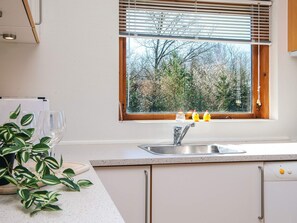 A kitchen with a window, a sink, and a plant. - 7 Person Holiday Home in Skals (Skals)
