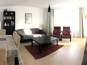 A modern living room with a sofa, two armchairs, a coffee table, and a bookshelf. - Talstrasse 22 App 13 Appartement/Fewo, Dusche oder Bad, WC 3½-Zimmerwohnung by Interhome (Davos)
