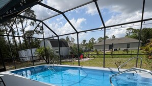 Ein überdachter Pool mit Metallgestell und blauem Wasser.