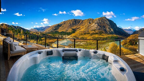 A hot tub on a deck with a mountain view. - Powder Ridge Alpine Retreat (Queenstown)