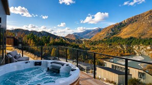 A hot tub on a deck with a mountain view. - Powder Ridge Alpine Retreat (Queenstown)