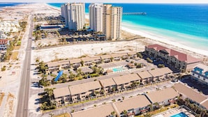 A coastal hotel with multiple buildings, a beach, and a pier. - 🌊🌴Geaux Coastal | Charming 2BR Home | Steps to Private Beach Access (Navarre)