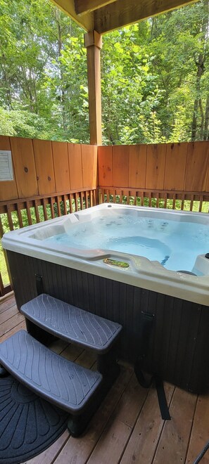 A hot tub on a wooden deck with steps leading up to it. - Bear Hug Hideaway: Secluded 2 King Cabin, Epic Arcade +Hot Tub, 4 min to Parkway (Sevierville)
