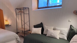 A bedroom with a bed, a bedside table, a lamp, a window, and a wall-mounted shelf. - Cosy apartment under vaulted ceiling-6 people- Le Secret d'Adèle (Châteauroux-les-Alpes)