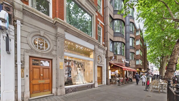 A street view with a boutique hotel, a large window display, and a tree-lined sidewalk. - BAZ Tower - London (London)