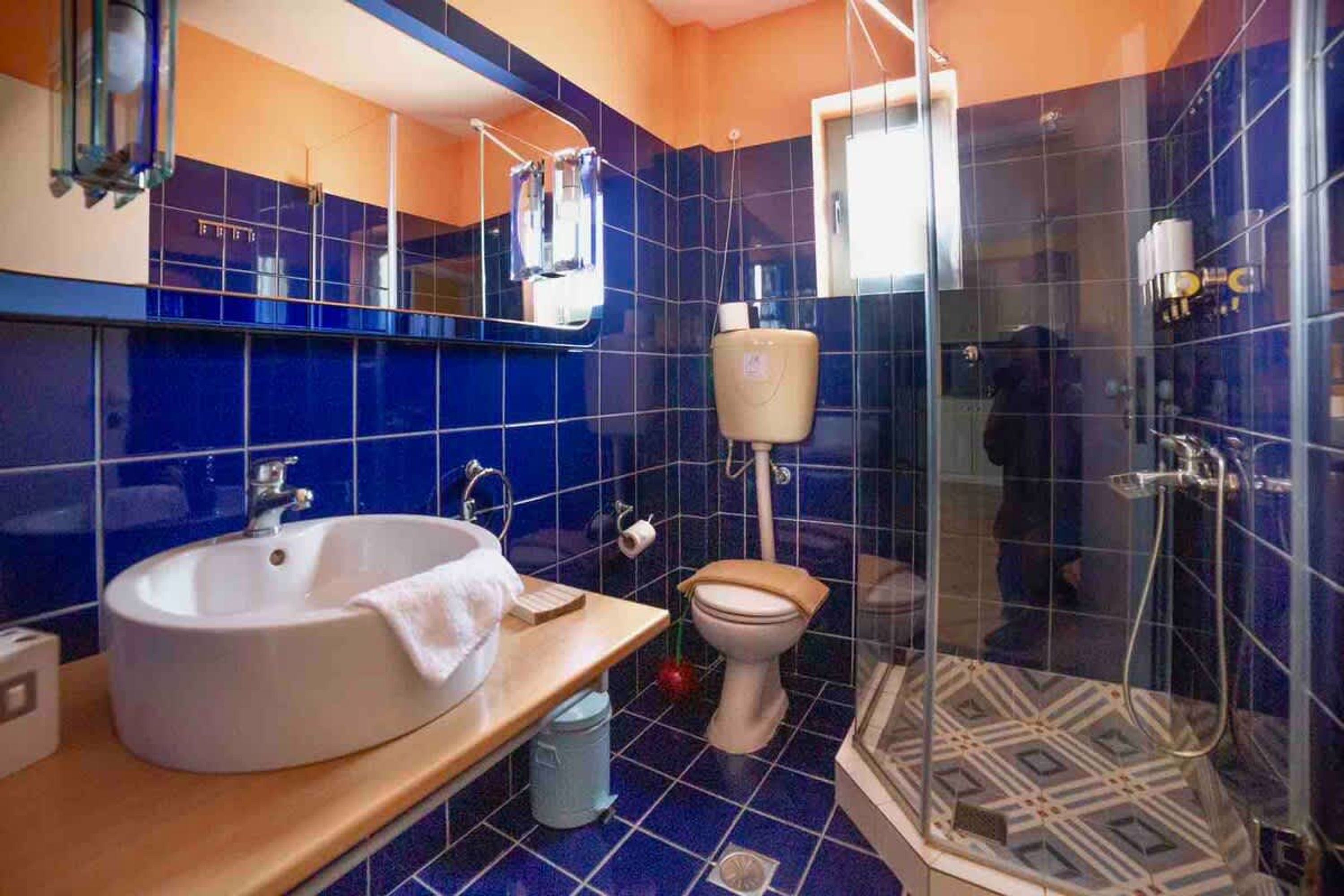 A bathroom with a sink, toilet, and shower.
