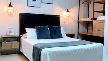 A modern bedroom with a bed, bedside tables, a wardrobe, and wall art.