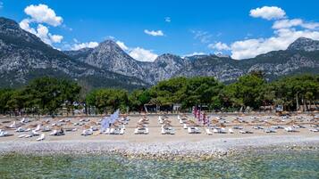 On the beach, sun loungers, beach umbrellas, beach towels