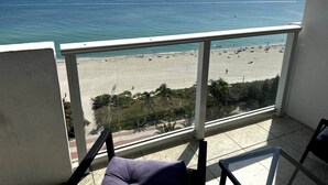 A balcony with a view of a beach and ocean. - 1128 - Ocean View with Balcony (Miami Beach)