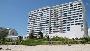 A multi-story hotel with a modern design, featuring a series of balconies and a prominent entrance. - 1128 - Ocean View with Balcony (Miami Beach)