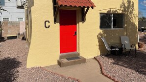 A small building with a red door, a window, and a 'C' on the wall. - Cherry red door cottage with AC in cool Phoenix C (Phoenix)