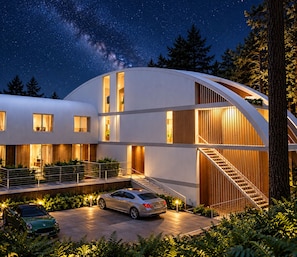 A modern building with a curved facade, large windows, and a staircase leading to an upper level. - Signature Lake View Luxury Residences A01 (San Carlos de Bariloche)