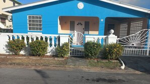A building with a blue facade, a white gate, and a number '59' sign. - Fabulous 1-bedroom apartment with AC in Saint Michael (Saint Michael)